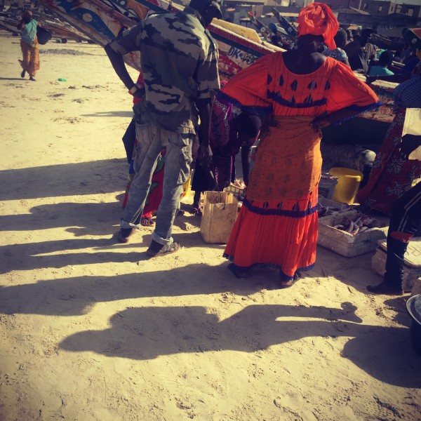 Vente de poisson sur le sable de plage de Yoff, une femme vêtue d'un boubou coloré, mains sur les hanches #Off2Africa 39 Dakar Sénégal © Gilles Denizot 2017